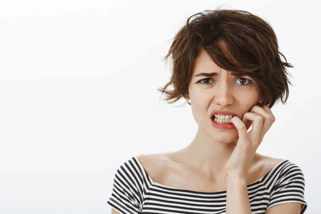 close up worried guilty cute woman grimacing nervously scaled 1