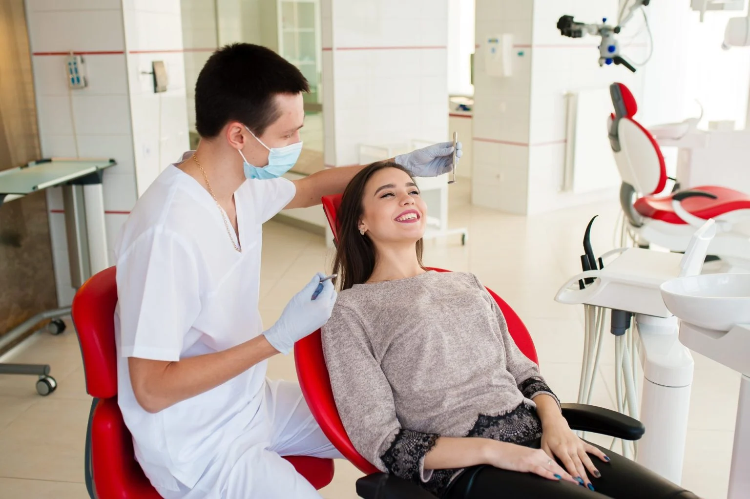 The dentist is treating teeth of a patient